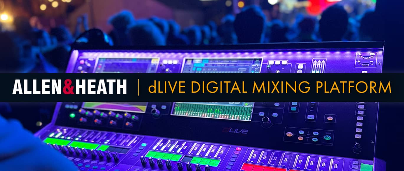 A dLIVE digital mixing console set up before a stage and a crowd of people.