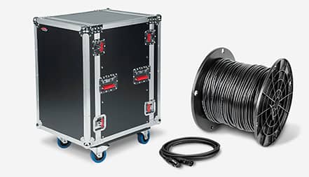A road case on wheels, a microphone cable, and spool of bulk wire