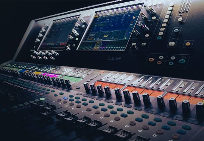 A close-up view of an Allen & Heath dLive digital mixing console with two touchscreens.